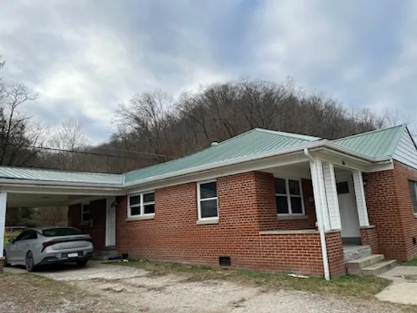 Professional seamless gutter installation on brick home